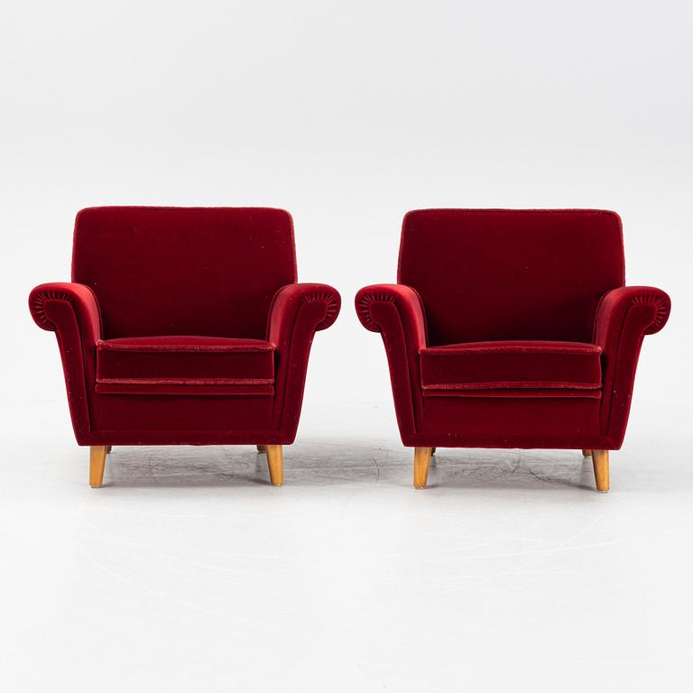 A pair of velvet upholstered easy chairs, mid 20th Century.