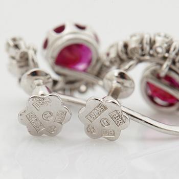 A pair of 18K white gold WA Bolin earrings set with faceted rubies and round brilliant- and eight-cut diamonds.