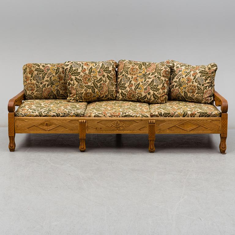 KNUT FJAESTAD, a folk art stained wood sofa/bed,  Sweden, early 20th C.