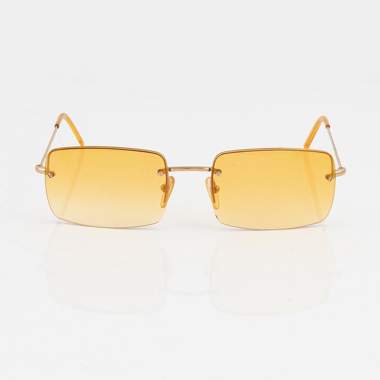 Gucci, a pair of gold and orange-toned glasses.