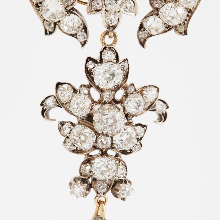 A 14K gold and silver brooch set with old-cut diamonds.