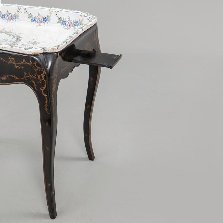 A Swedish Rococo faience tea table, Marieberg 1770.