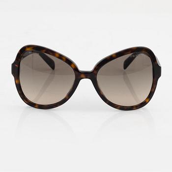 Prada, a pair of tortoise color sunglasses.