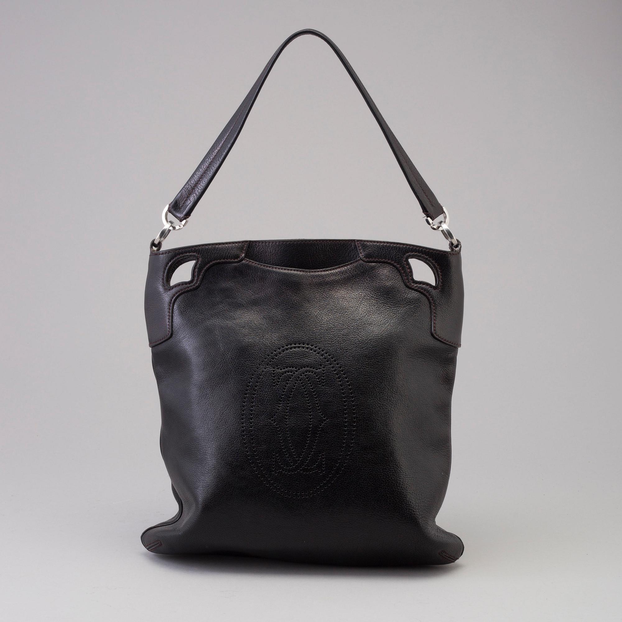 A bag "Marcello Reporter" by Cartier.