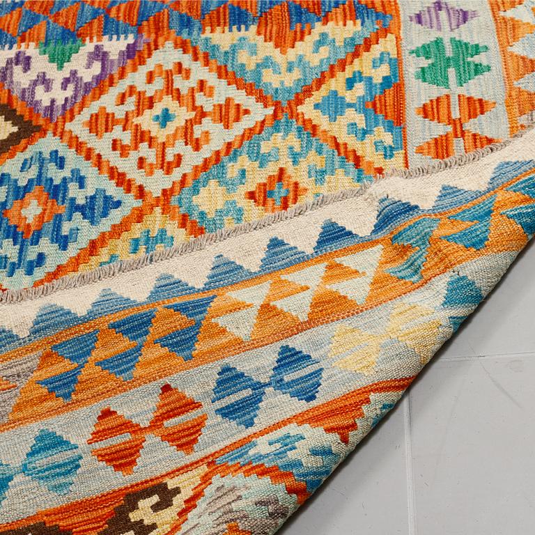 A kilim rug, 298 x 218 cm.