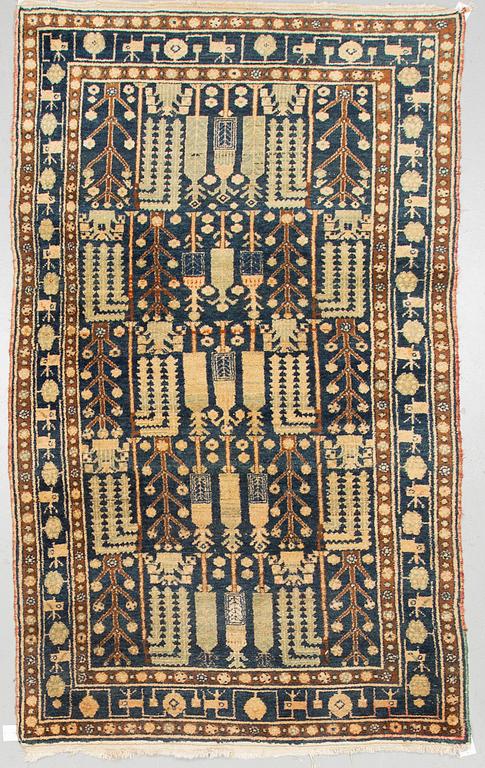 A RUG, a semi-antique West Persian, ca 239-247 x 140,5-147,5 cm (as well as ca 3 cm flat weave at the ends).