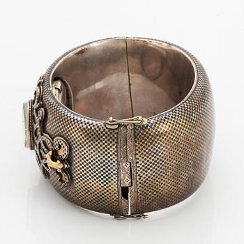 Silver bangle with watch.