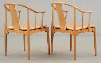 A pair of Hans J Wegner cherrywood and beige leather 'China chairs', Fritz Hansen, Denmark 1988.