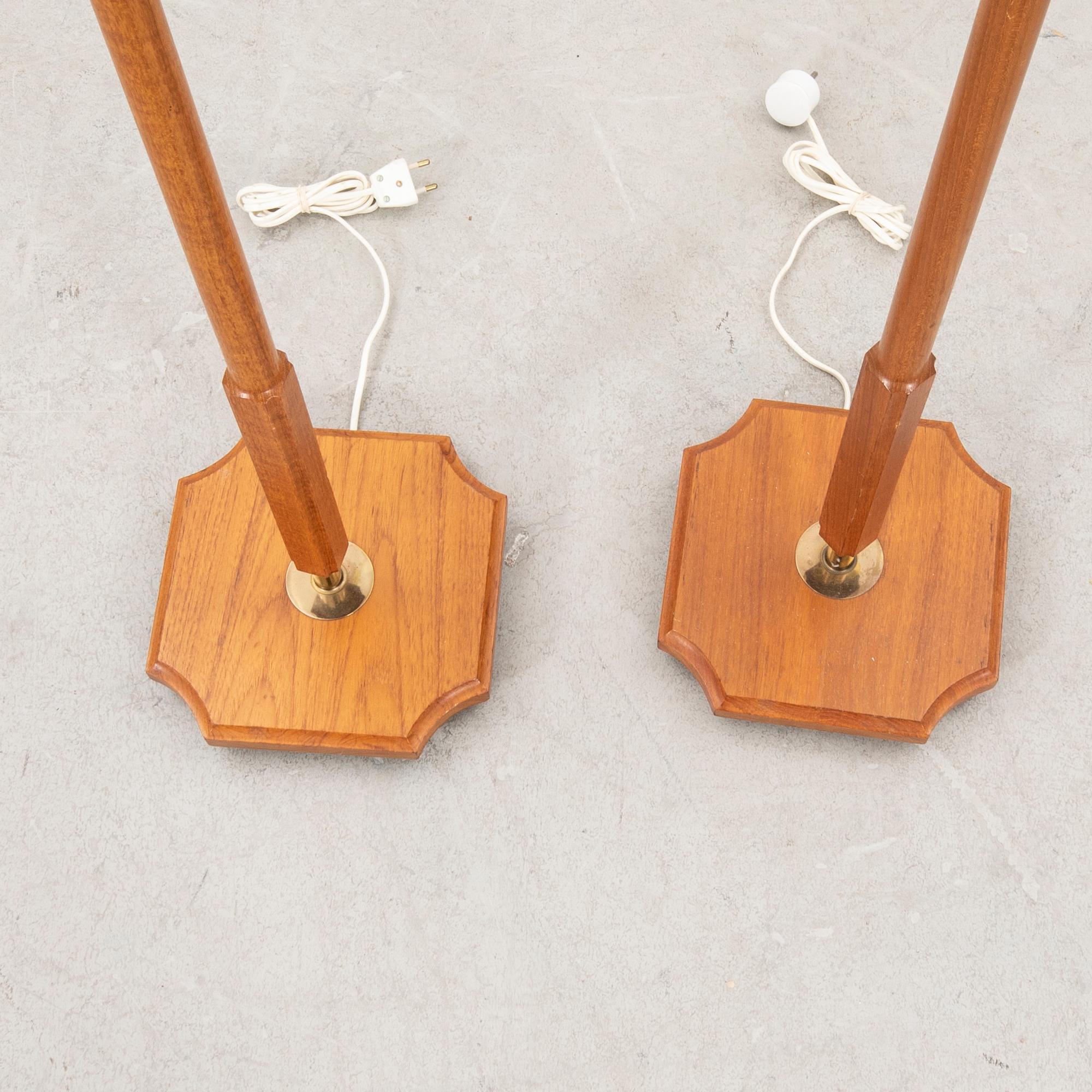 A pair of 1960s teak floor lamps.