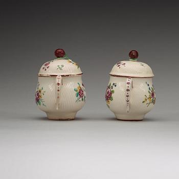 A pair of Swedish soft paste custard cups with covers, Marieberg, 18th Century.