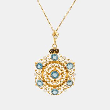 509. An 18K gold pendant set with faceted aquamarine and pearls.