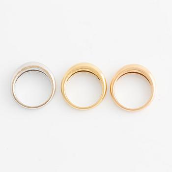 Three rings in 18K gold in various colors.