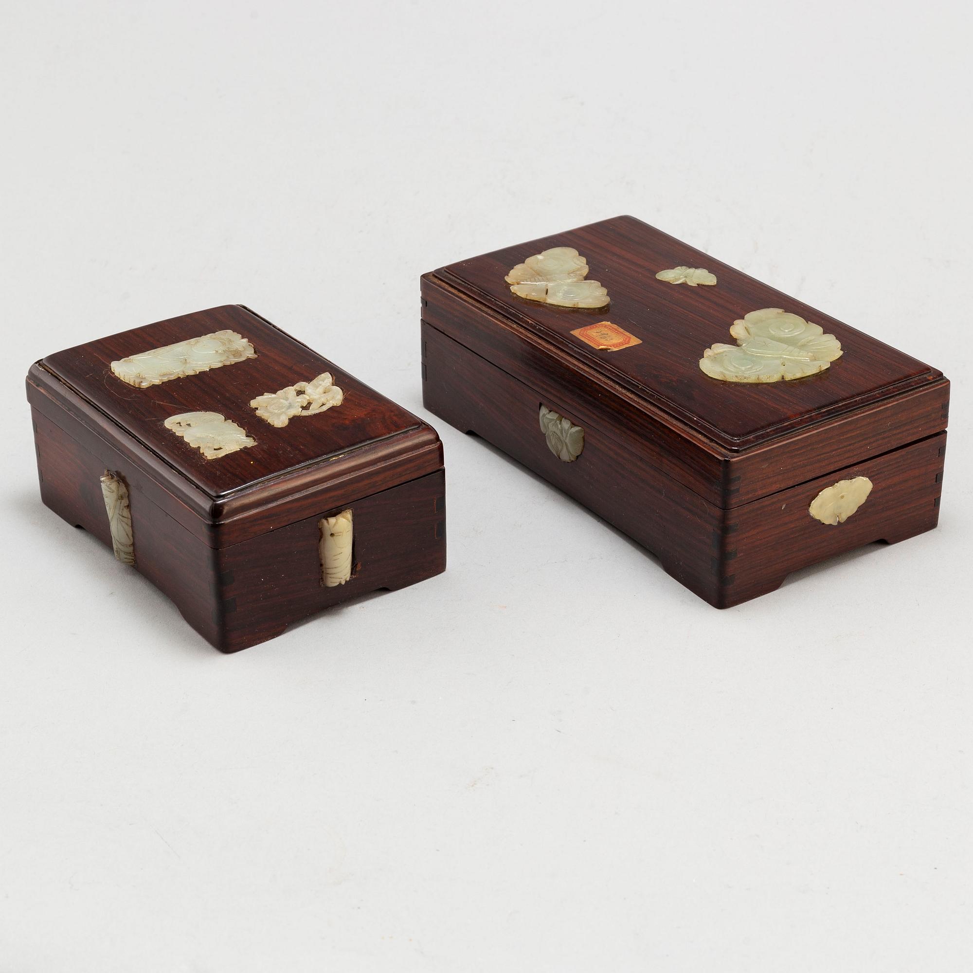 Two Chinese wooden boxes with covers, with nephrite objects, 20th century.