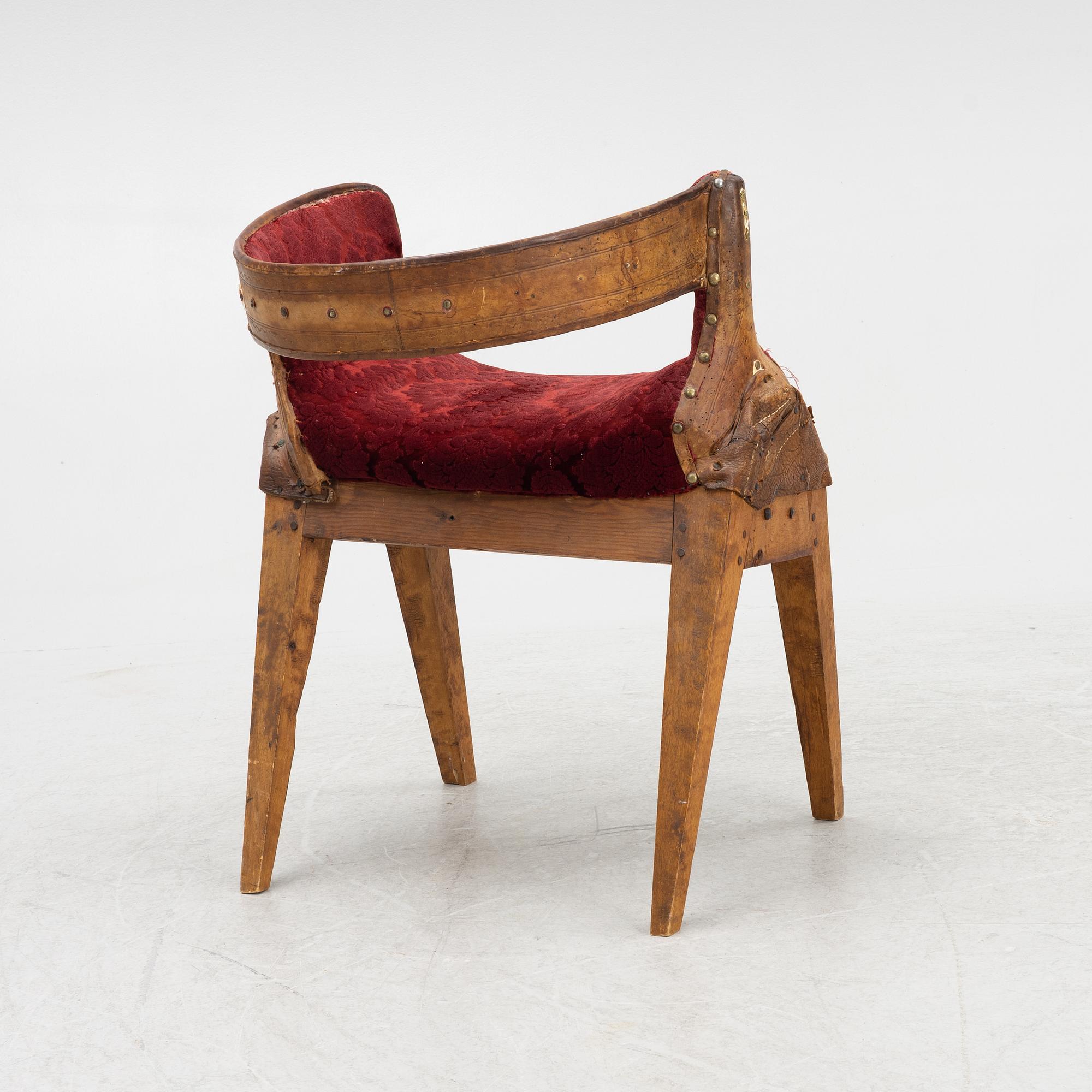 A side saddle, 18th/19th Century, mounted on legs.