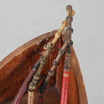 A 19th century pipe-rack with ten pipes and accessories.