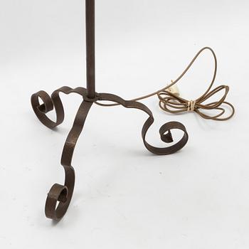 An iron floor lamp, early 20th Century.