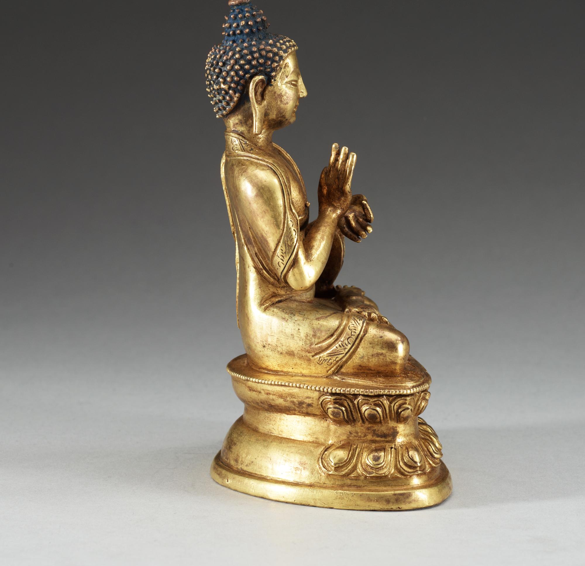 A gilt copper Buddha, presumably Qing dynasty, with Qian Long seven character mark.