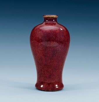 A ruby coloured Meiping vase, with areas of light celdon and blue colour, Qing dynasty (1644-1912).