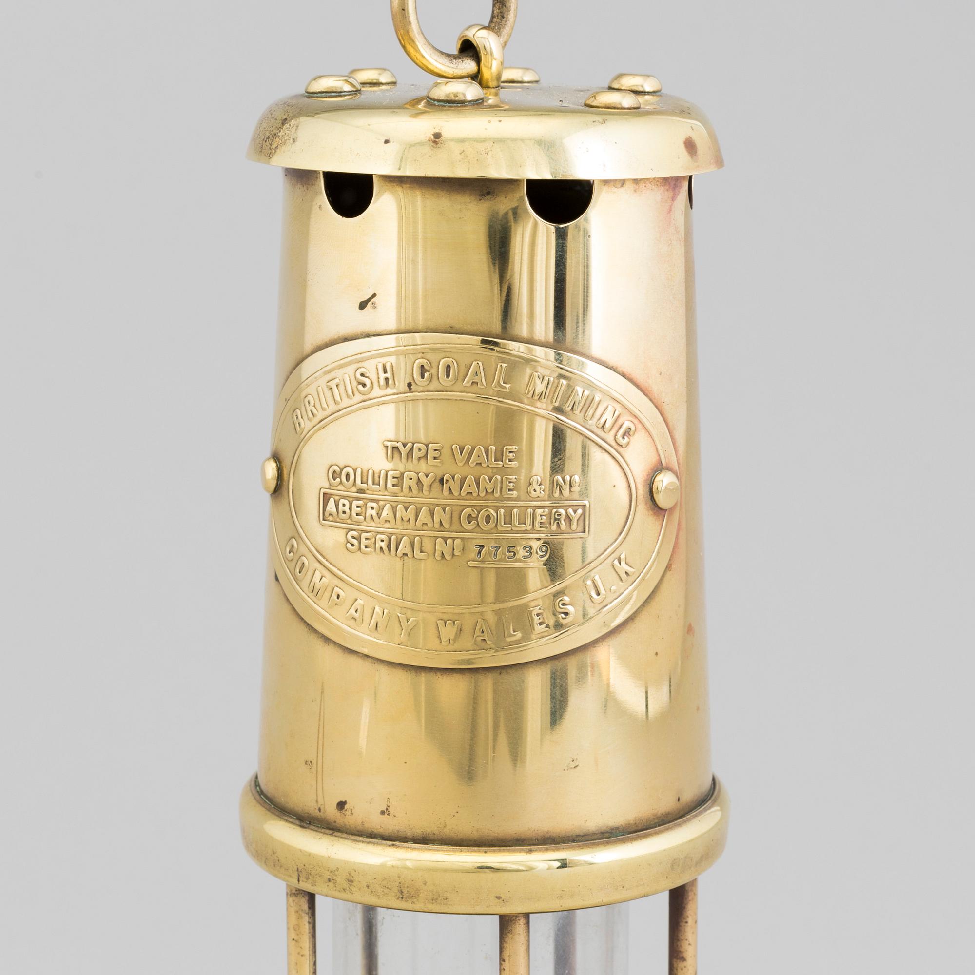 A 20th century cole brass and glass mining lamp. Bukowskis