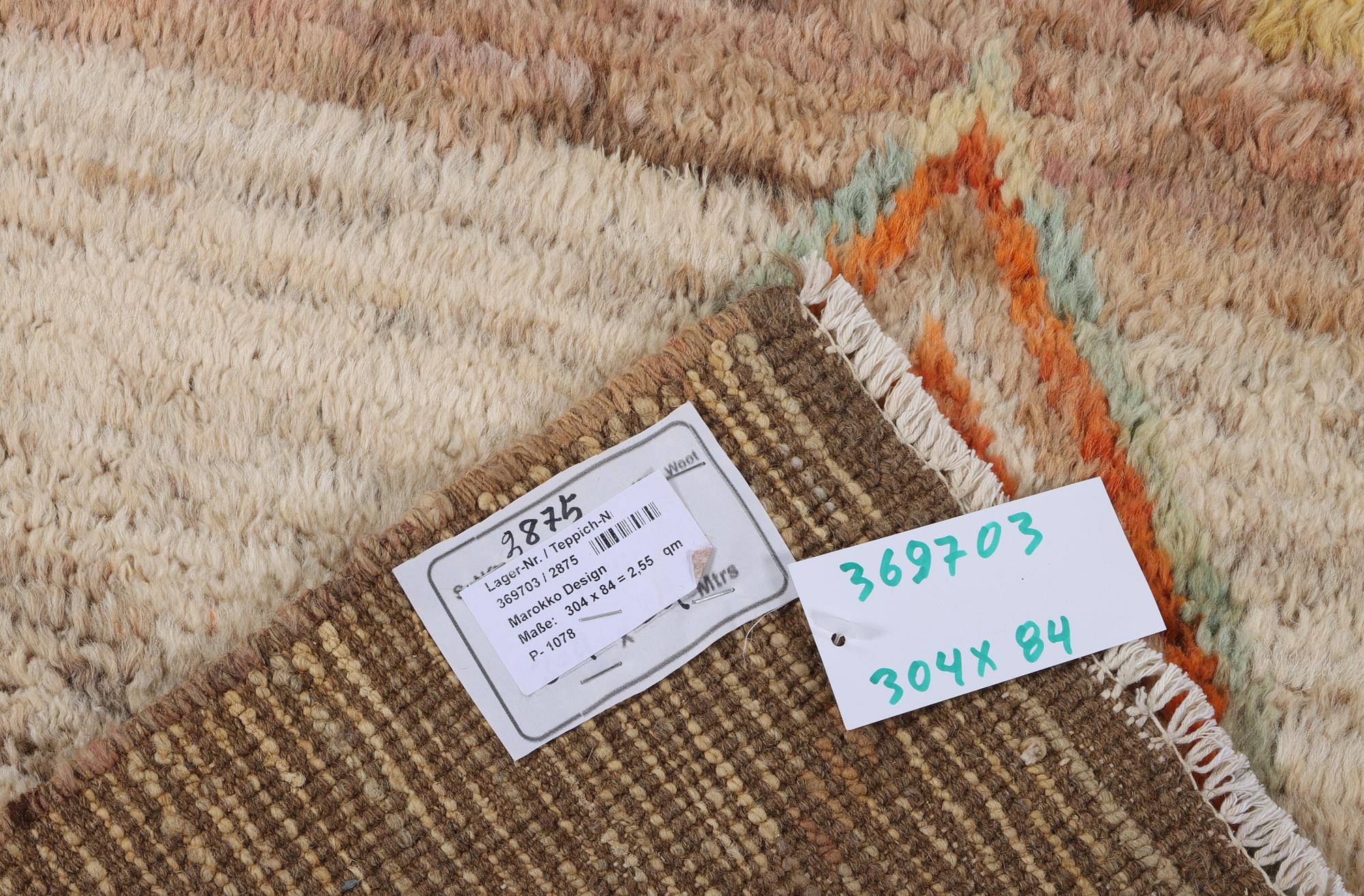 A Moroccan runner carpet, c. 304 x 84 cm.