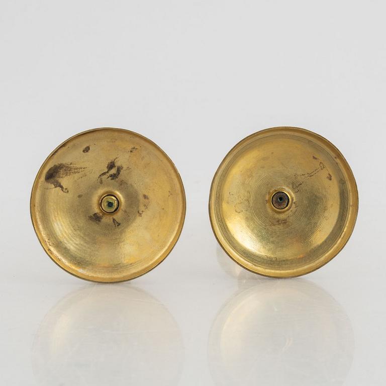 A pair of brass candlesticks, first half of the 19th Century.