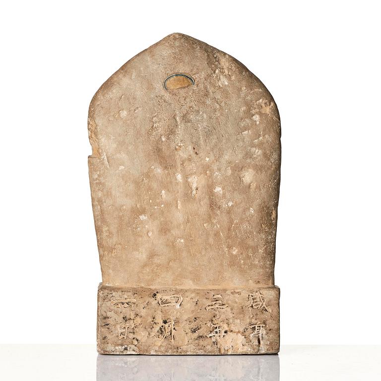 An inscribed limestone Buddhist stele, Tang style, with an inscription the third year of the Xian, corresponding to 672.