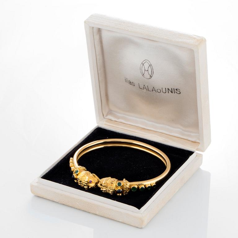 An Ilias Lalaounis bracelet in 18K gold set with emeralds, sapphires and rubies.