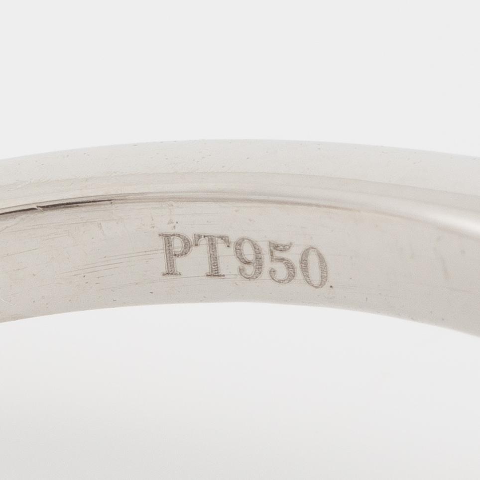 Ring, Fred Leighton platinum with an oval faceted tanzanite and fancy-cut diamonds.