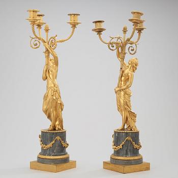 A pair of Louis XVI circa 1780 three-light gilt bronze and bleu turquin marble candelabra.