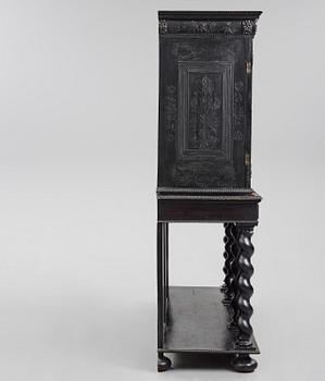 A Louis XIV and Louis XIV-style carved ebony, ivory and tortoiseshell-inlaid cabinet on stand, 17th and 19th century.