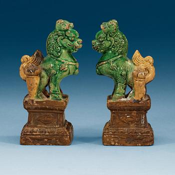 A pair of brown, green and yellow glazed joss stick holders, Qing dynasty (1644-1912).