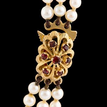 A three strand cultured pearl necklace.