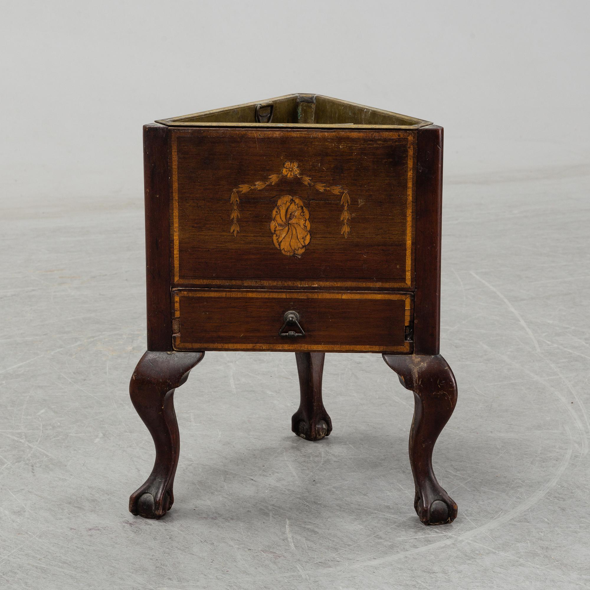 An English mahogany veneered wine cooler, circa 1900.