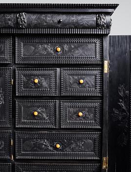 A Louis XIV and Louis XIV-style carved ebony, ivory and tortoiseshell-inlaid cabinet on stand, 17th and 19th century.