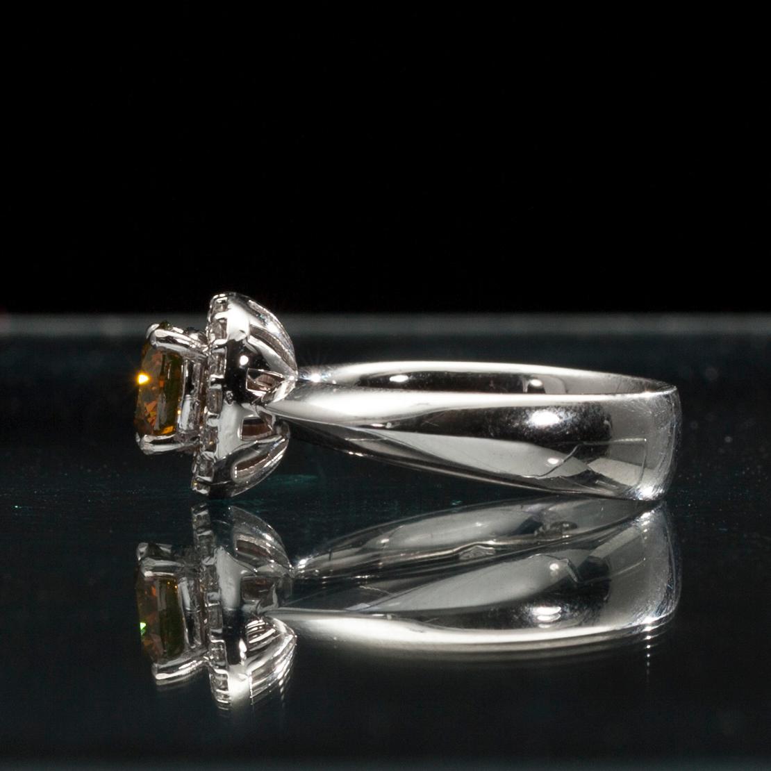 RING, 18K vitguld, briljantslipad diamant 1,11 ct. 16 st. diamanter tot. 0,22 ct. Vikt 8,8 g. Intyg.