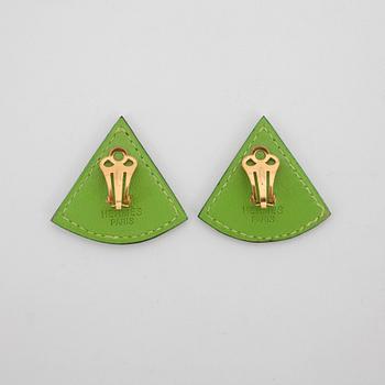 HERMÈS, a pair of green leather clip earings from the 1990s.