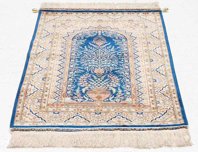 A semi-antique silk Hereke rug, West Anatolia, signed c. 107 x 72 cm.