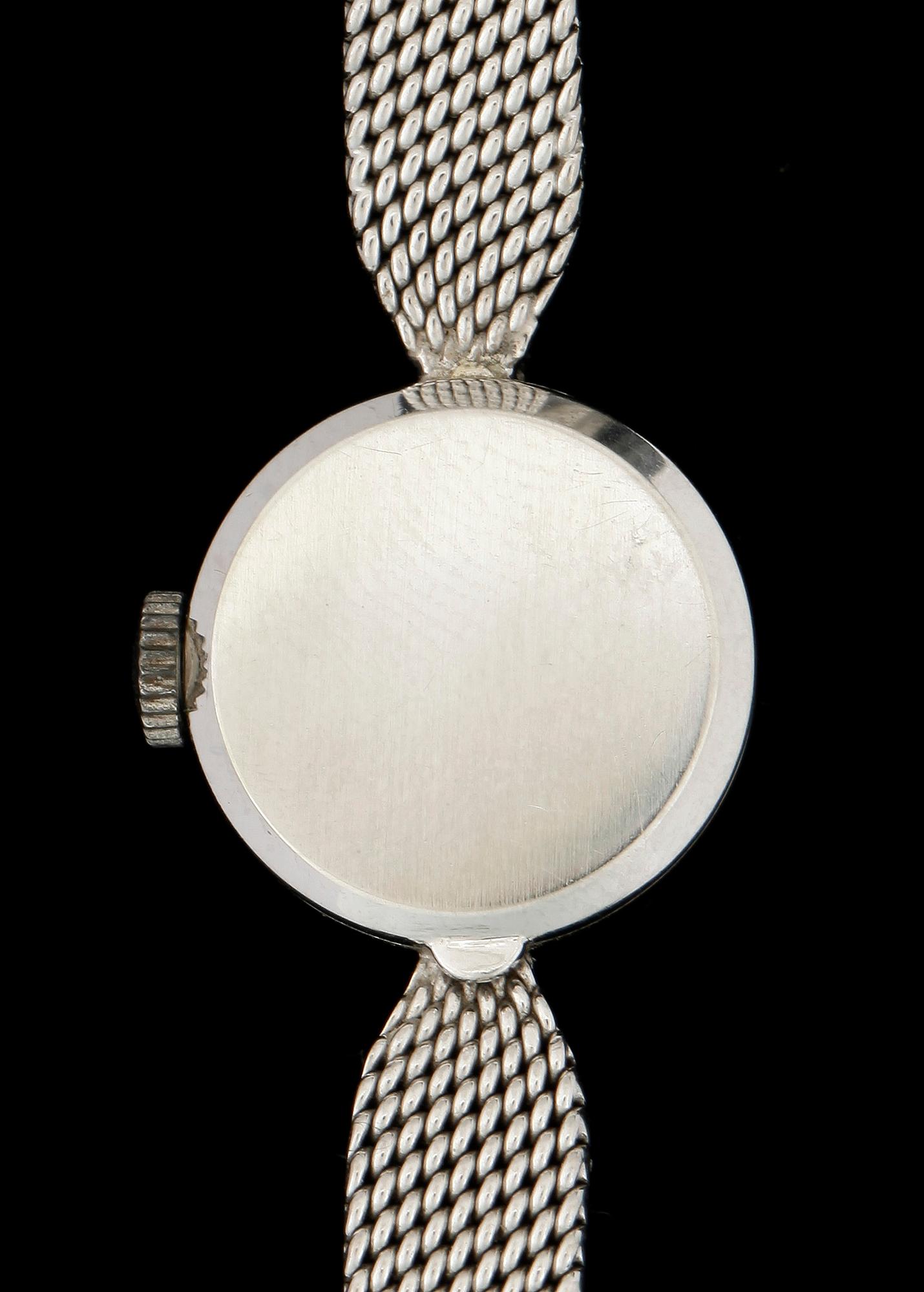 DAMARMBANDSUR, vitguld 18k, två små briljantslipade diamanter, Movado. Vikt ca 22 gram.