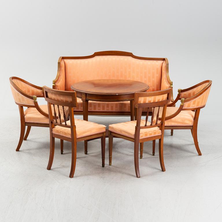 An Empire style table, a sofa and eight chairs, early 20th Century.