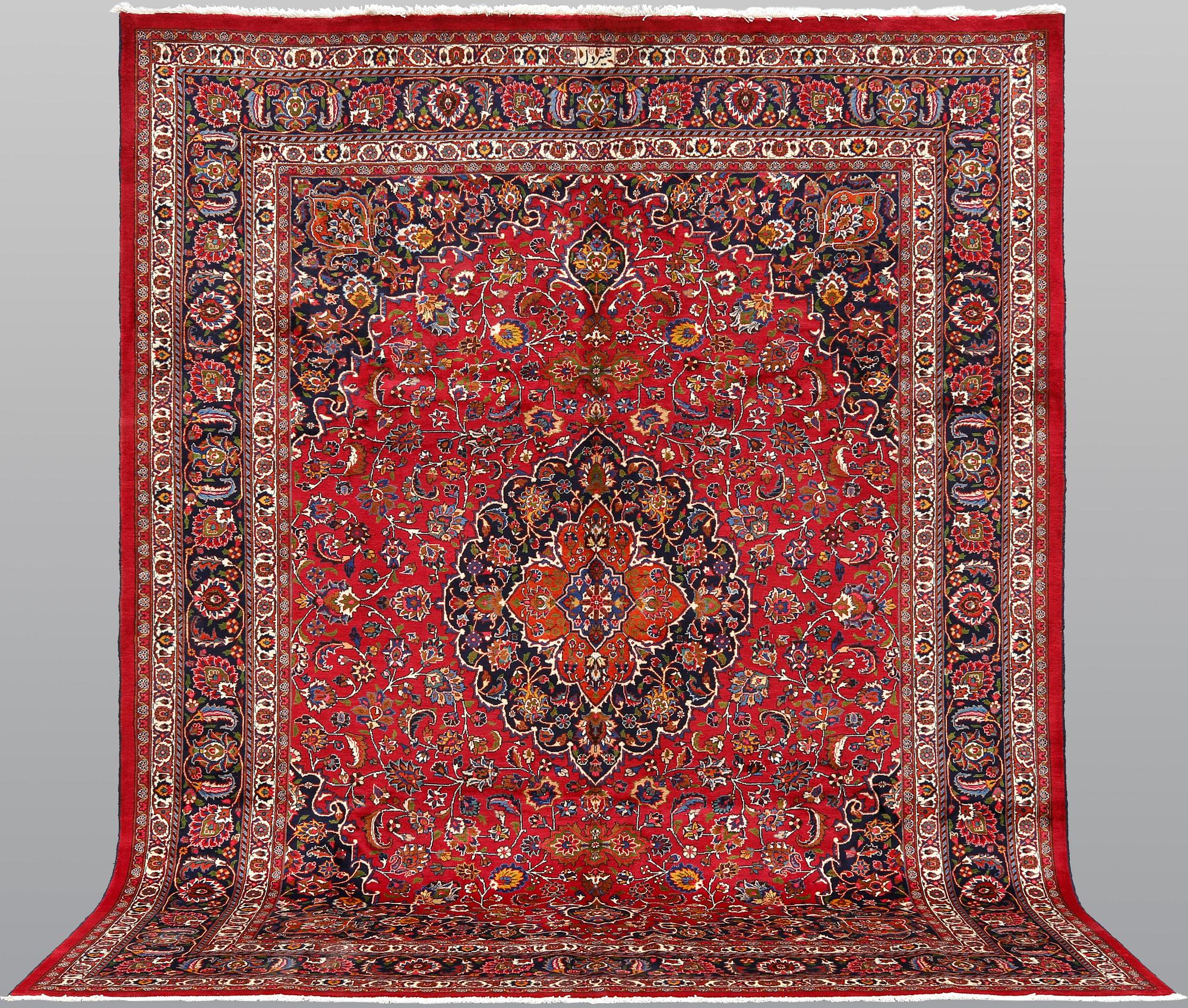 A signed Mashad carpet, ca 375 x 303 cm.