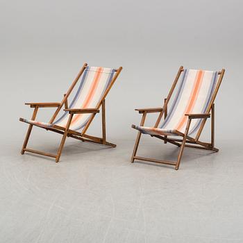 A pair of  mid 20th century beach chairs.