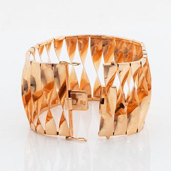 A 14K gold bracelet and a brooch.