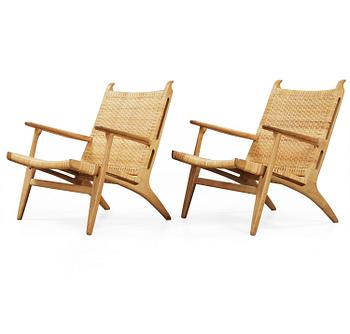 A pair of Hans J Wegner oak and rattan easy chairs 'CH-27', Carl Hansen & Son, Denmark.