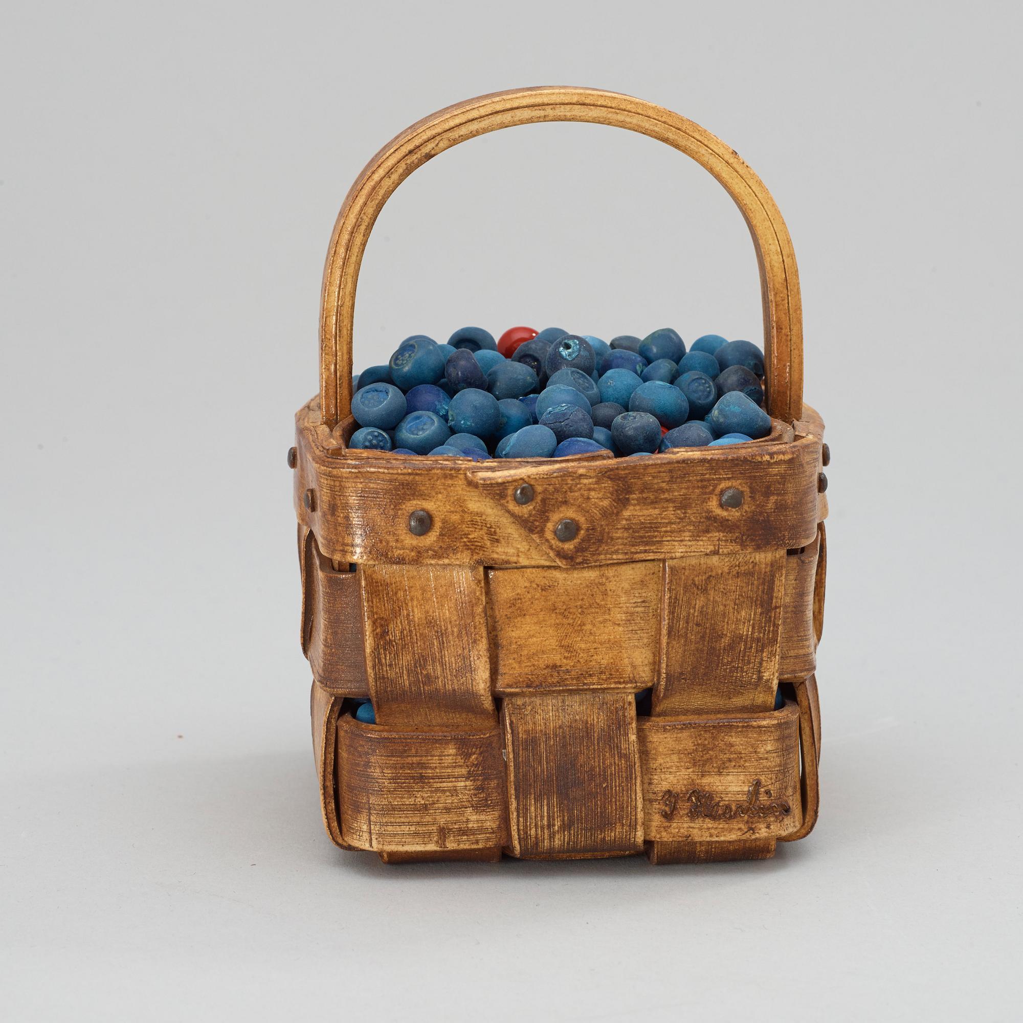 An Ingrid Herrlin stoneware blueberry basket with two lingonberries, Båstad, Sweden.