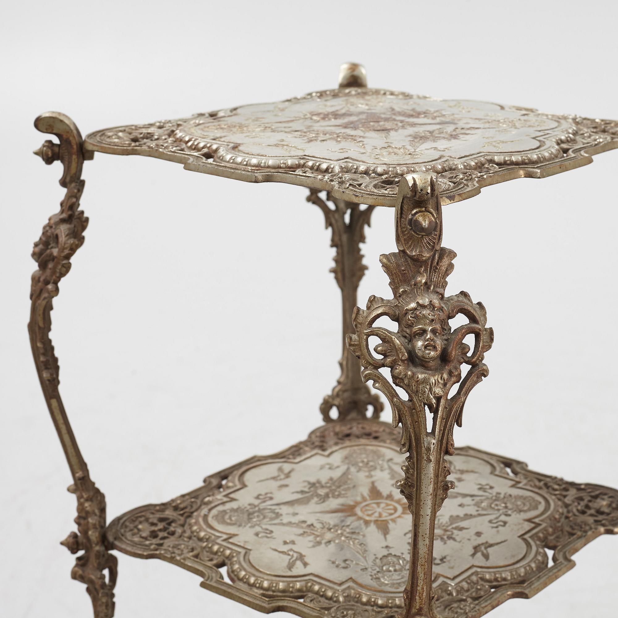 A three-tiered metal pedestal, first half of the 20th century.