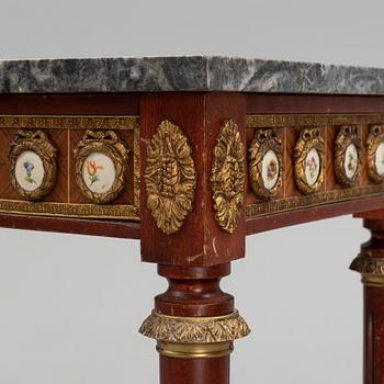 A Louis XVI style console table with a marble top.
