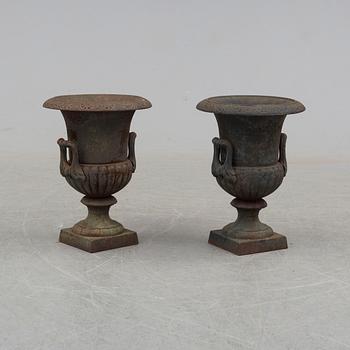 A pair of 20th century iron garden urns.