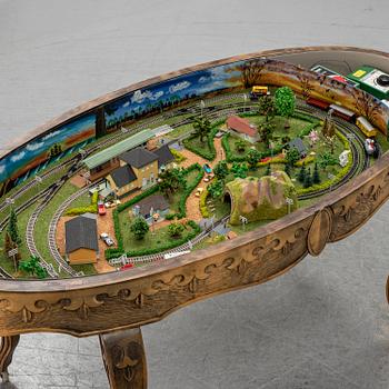 A table with a mini-trix modeltrain inside.