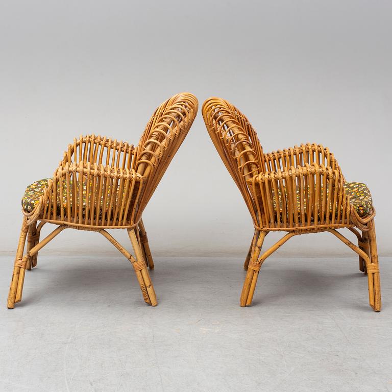 A pair of rattan armchairs, Emilio Paoli, via Vigna Nuova, 8, Firenze, Italy, second half of the 20th century. Signed.