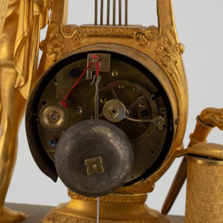 A French Empire ormolu figural mantel clock, early 19th century.